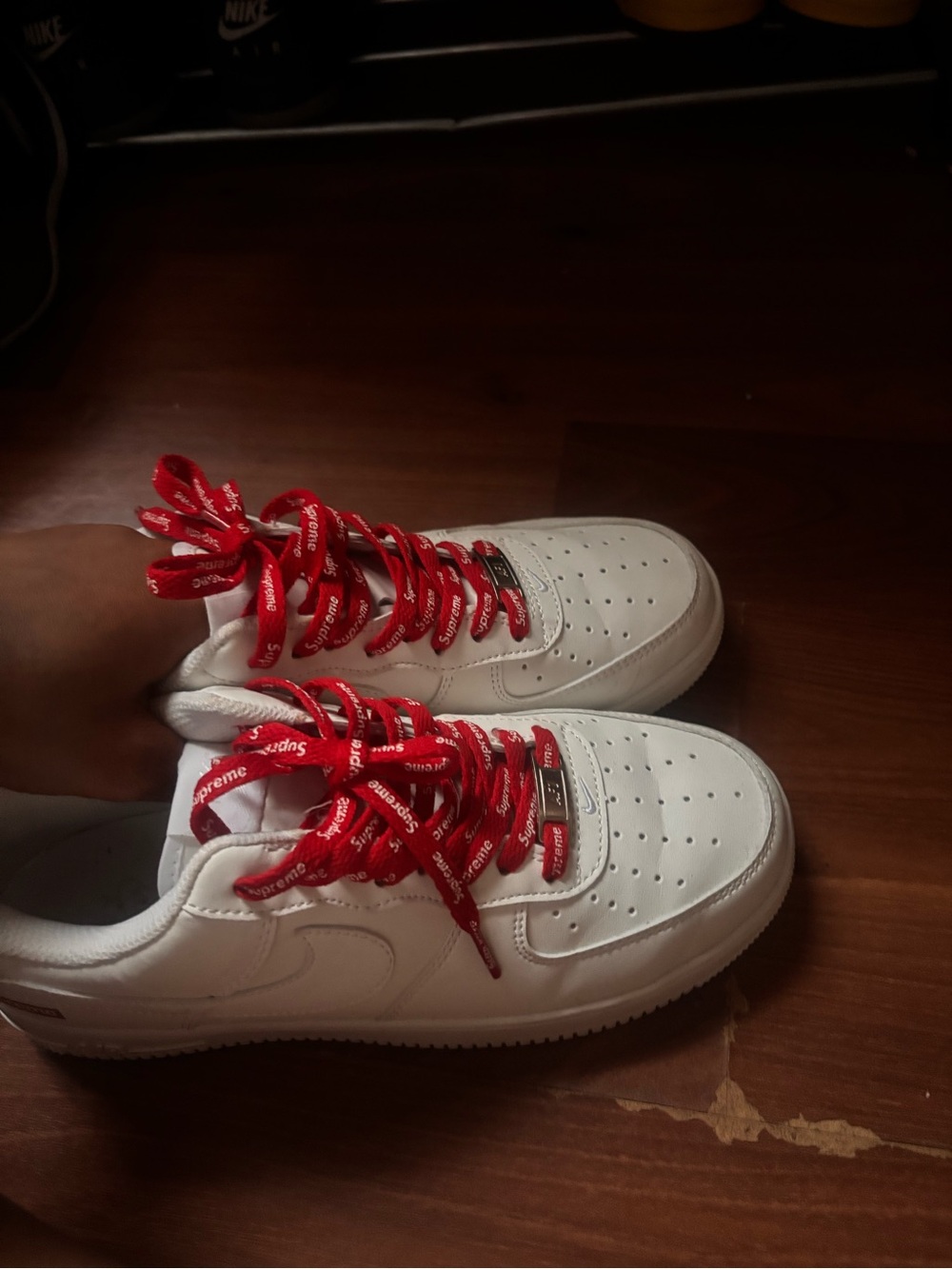 Nike white sneakers with red Supreme laces